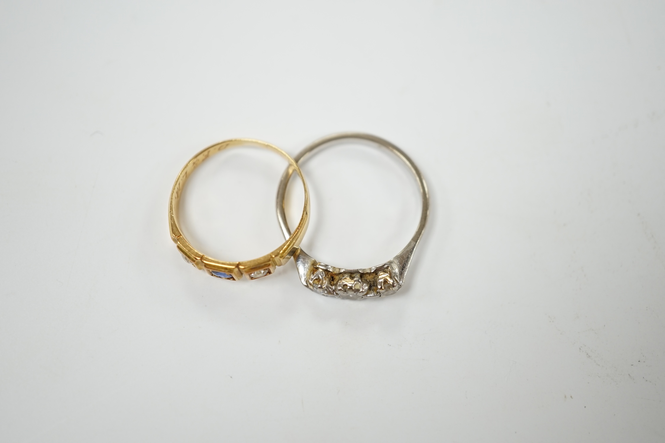 An Edwardian 18ct gold sapphire and diamond set three stone ring, size L, together with a white metal and three stone diamond ring, size N, gross weight 4.7 grams. Condition - fair